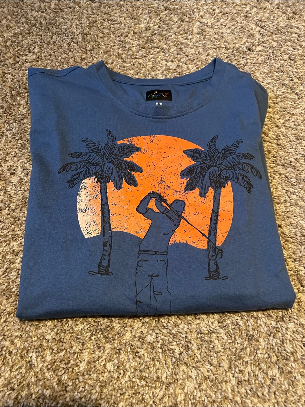 Greg Norman Collection Blue Short Sleeve Tee with Orange Golf Sunset Graphic